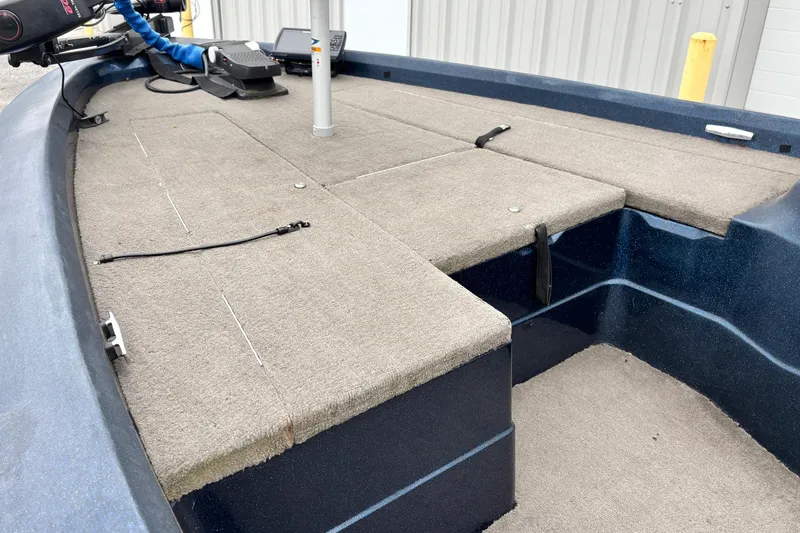 Slide: The Image of 1998 Nitro 800 LXS boat interior with carpeted deck and fishing equipment. - 3