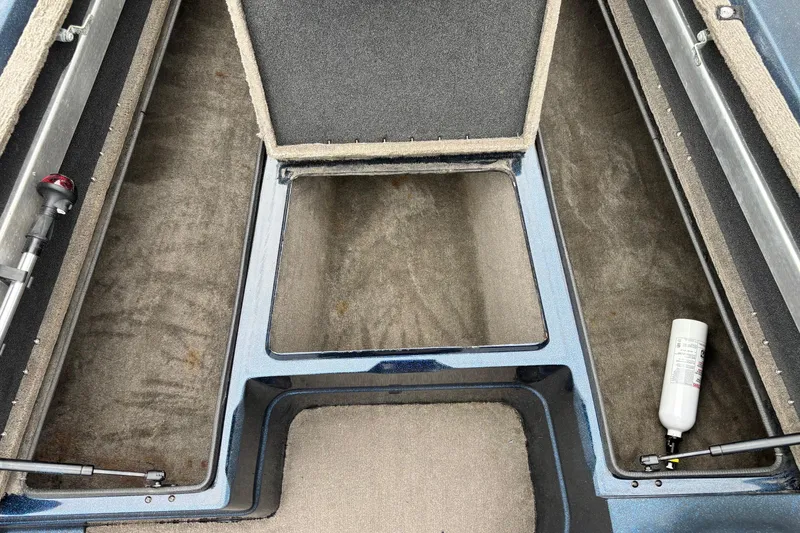 Slide: The Image of 1998 Nitro 800 LXS boat interior storage compartments with carpeted surfaces and hydraulic struts. - 4
