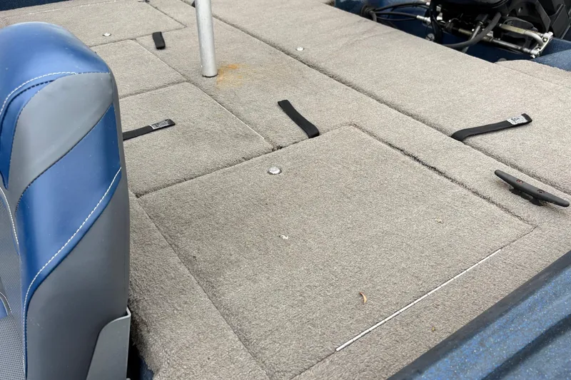 Slide: The Image of Interior of a 1998 Nitro 800 LXS boat with gray carpet and blue seat. - 8