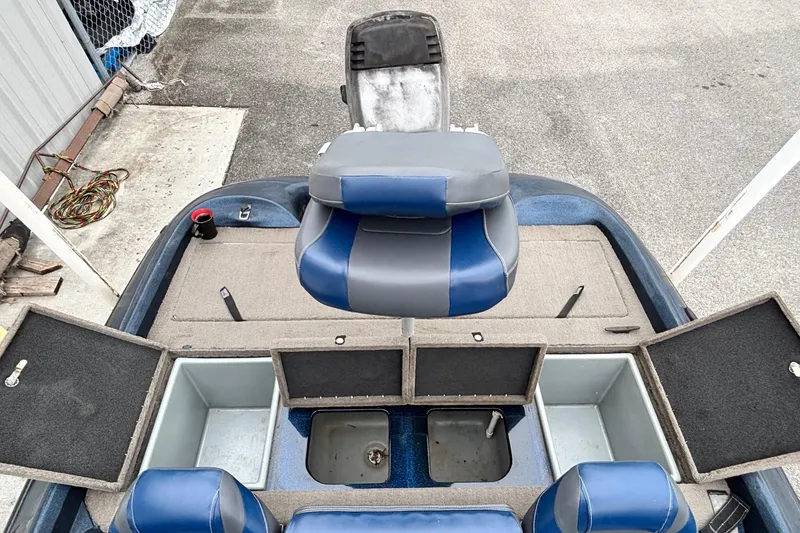 Slide: The Image of 1998 Nitro 800 LXS boat interior with blue seats and open storage compartments. - 9