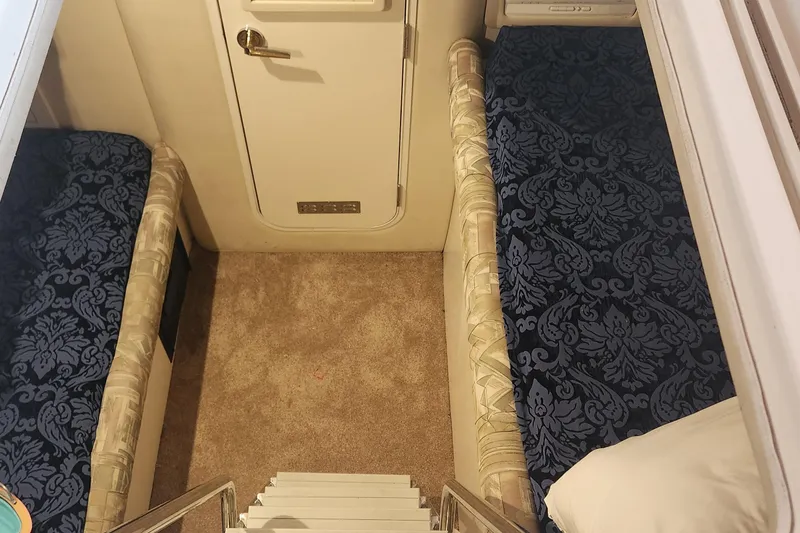 Slide: The Image of Interior cabin of 1998 Sea Ray 630 Super Sun Sport with patterned bedding. - 17