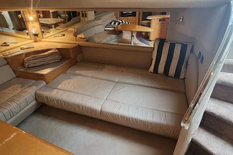 Slide: The Image of Interior of 1998 Sea Ray 630 Super Sun Sport yacht with beige seating and striped pillow. - 21