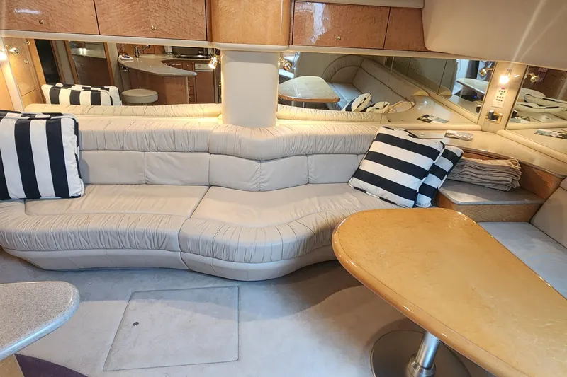 Slide: The Image of Luxurious interior of 1998 Sea Ray 630 Super Sun Sport yacht with plush seating and striped cushions. - 22