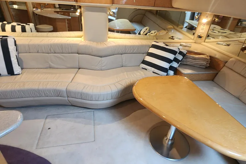 Slide: The Image of Luxurious interior of 1998 Sea Ray 630 Super Sun Sport yacht with plush seating and striped cushions. - 23