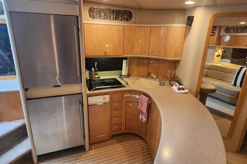 Slide: The Image of Luxurious 1998 Sea Ray 630 Super Sun Sport yacht kitchen interior with modern appliances. - 24