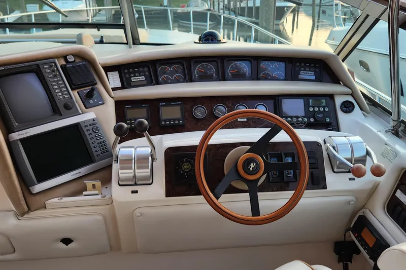 Slide: The Image of 1998 Sea Ray 630 Super Sun Sport helm with navigation instruments and wooden steering wheel. - 3
