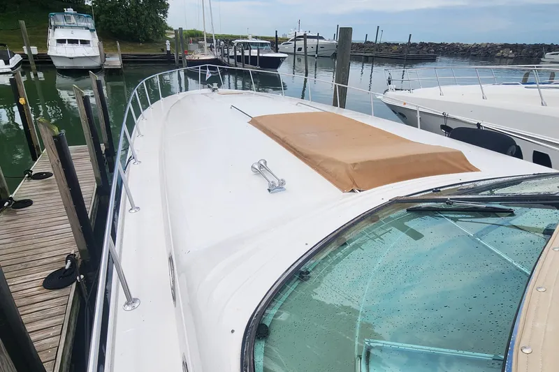 Slide: The Image of 1998 Sea Ray 630 Super Sun Sport yacht docked at marina, showcasing sleek design. - 30