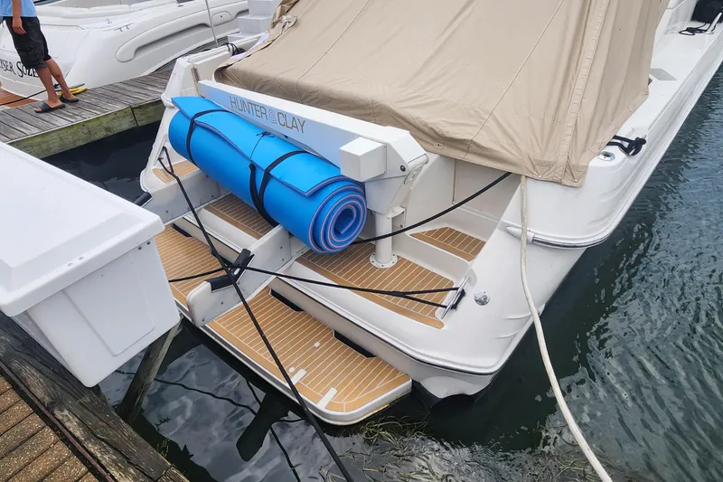 Slide: The Image of 1998 Sea Ray 630 Super Sun Sport yacht docked with blue mat and beige cover. - 33