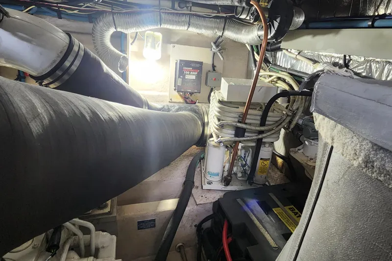 Slide: The Image of Engine room of a 1998 Sea Ray 630 Super Sun Sport with visible wiring and components. - 38