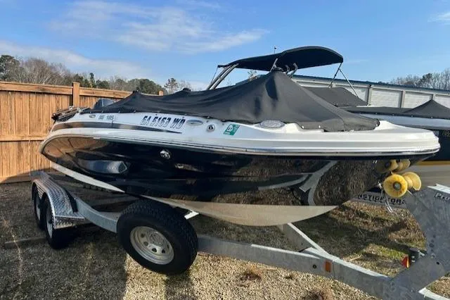 Slide: The Image of 2021 Hurricane SunDeck Sport 185 OB boat on trailer, covered and parked outdoors. - 15