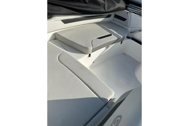 Slide: The Image of 2021 Hurricane SunDeck Sport 185 OB boat interior with white seating and storage area. - 17