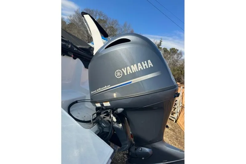 Slide: The Image of 2021 Hurricane SunDeck Sport 185 OB with Yamaha outboard motor, outdoor setting. - 21