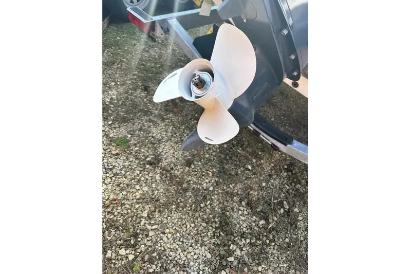 Slide: The Image of 2021 Hurricane SunDeck Sport 185 OB boat propeller on gravel surface. - 22
