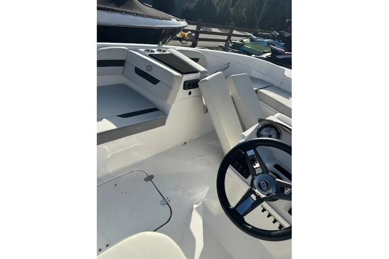 Slide: The Image of 2021 Hurricane SunDeck Sport 185 OB boat interior with steering wheel and seating. - 23
