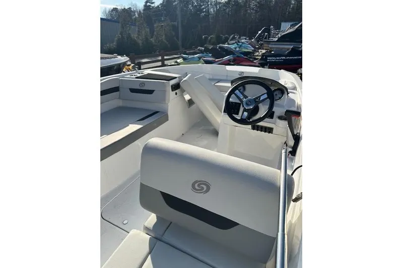 Slide: The Image of 2021 Hurricane SunDeck Sport 185 OB boat interior with steering wheel and seating. - 25