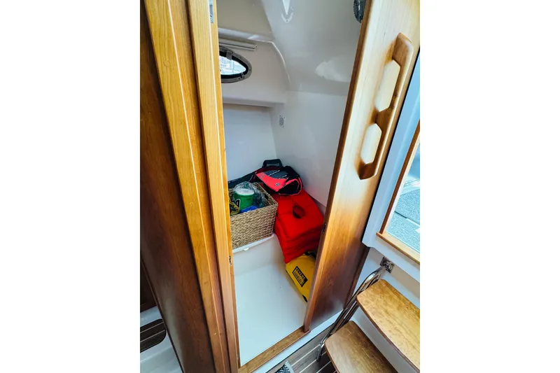 Slide: The Image of Storage compartment in 2025 Back Cove 34O boat with life jackets and supplies. - 13