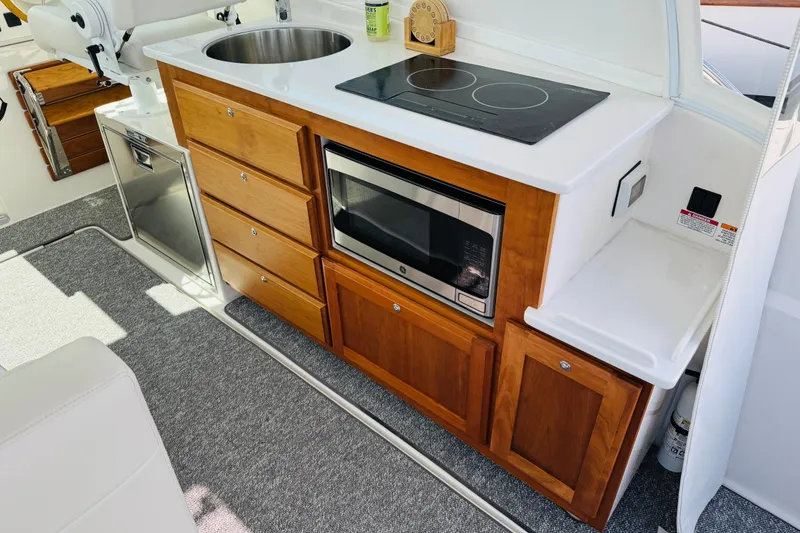 Slide: The Image of Modern galley kitchen in 2025 Back Cove 34O boat with stove, sink, and microwave. - 14