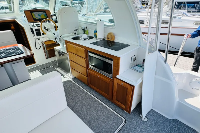 Slide: The Image of Interior of 2025 Back Cove 34O yacht with modern kitchen and navigation area. - 15
