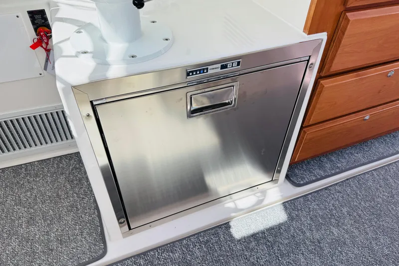 Slide: The Image of Stainless steel appliance on 2025 Back Cove 34O boat, next to wooden drawers. - 16