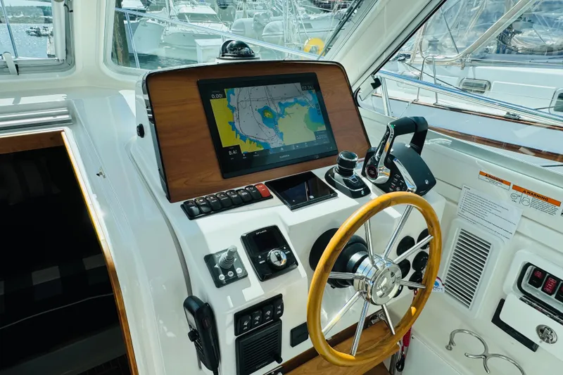 Slide: The Image of Helm of 2025 Back Cove 34O boat with navigation display and controls. - 17