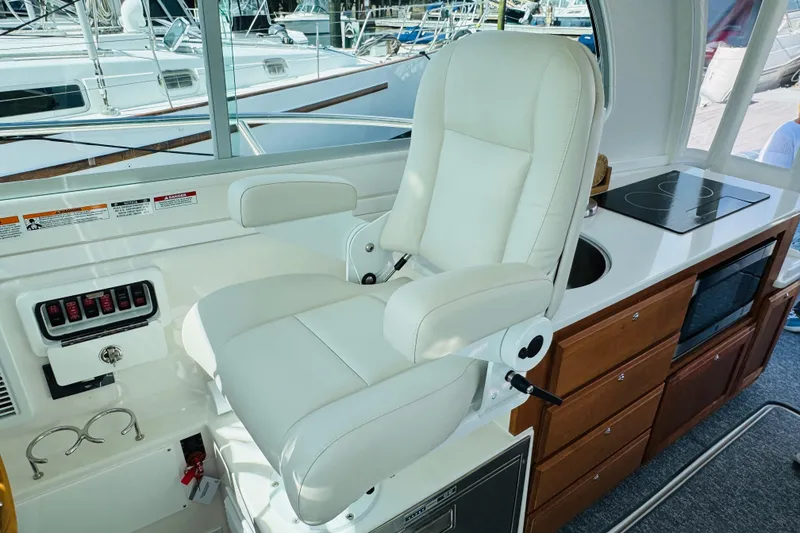 Slide: The Image of Luxury helm seat and galley in 2025 Back Cove 34O yacht interior. - 19