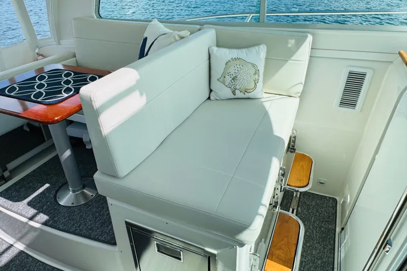 Slide: The Image of Luxurious interior of 2025 Back Cove 34O yacht with white seating and wooden accents. - 20