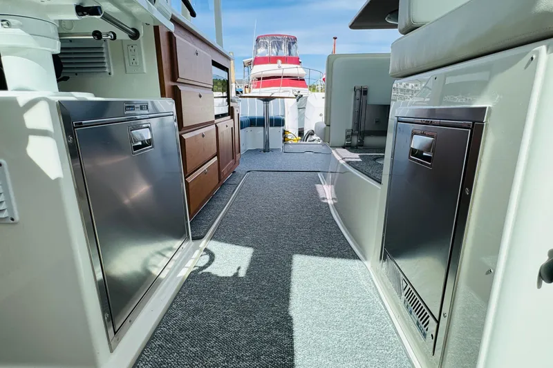 Slide: The Image of 2025 Back Cove 34O yacht interior with modern appliances and wooden cabinetry. - 26