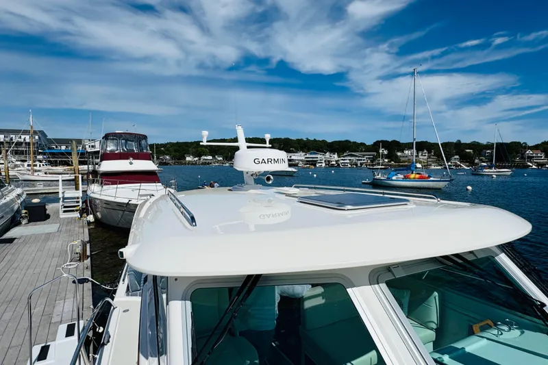 Slide: The Image of 2025 Back Cove 34O docked at marina with clear blue sky. - 34
