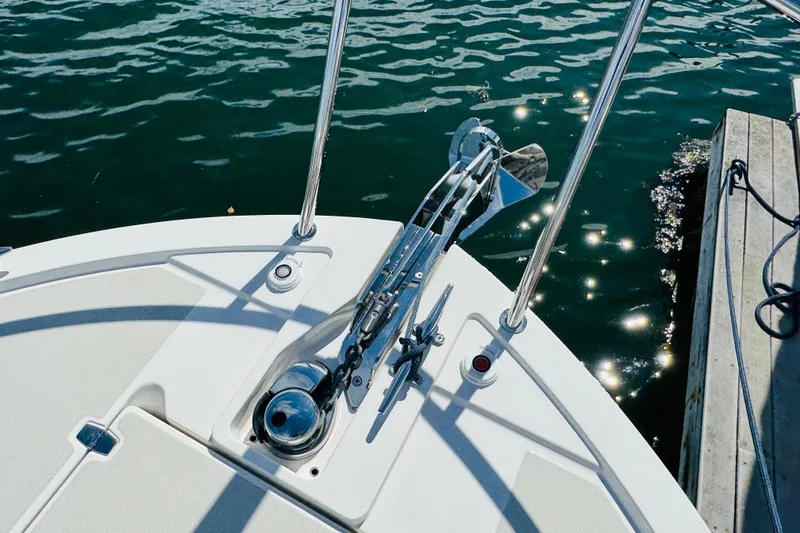 Slide: The Image of Bow of 2025 Back Cove 34O boat with anchor, docked on sparkling water. - 36