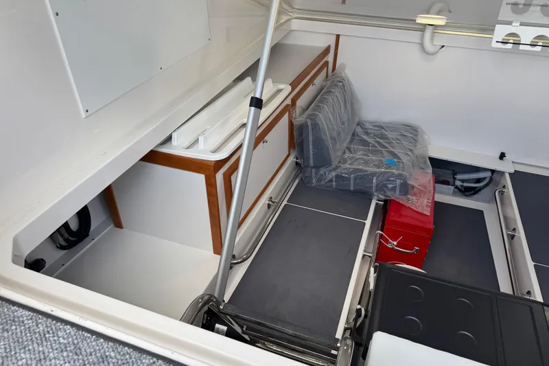 Slide: The Image of 2025 Back Cove 34O boat interior storage area with seating and equipment. - 38