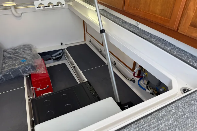 Slide: The Image of 2025 Back Cove 34O boat interior storage compartment with equipment and cabinetry. - 39