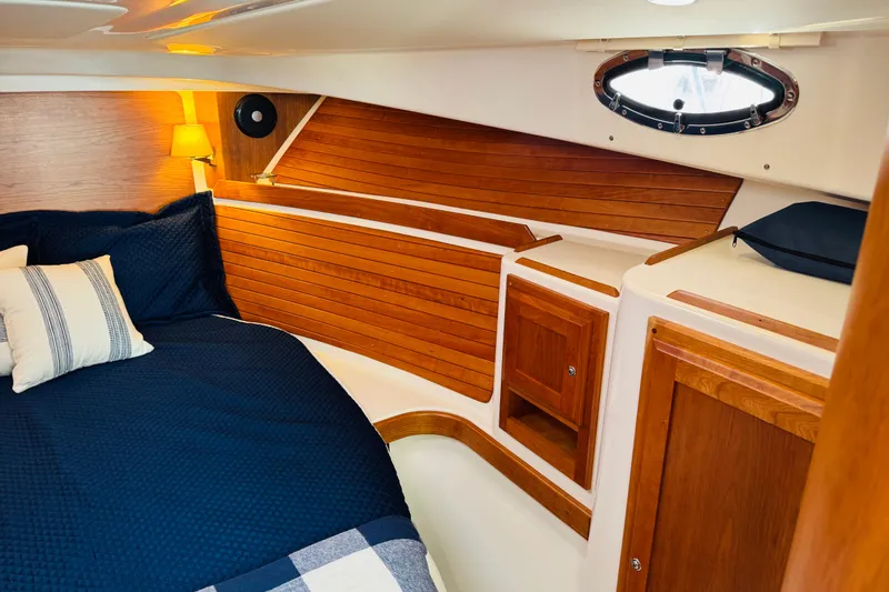 Slide: The Image of Luxurious cabin interior of 2025 Back Cove 34O with wood paneling and cozy bedding. - 4