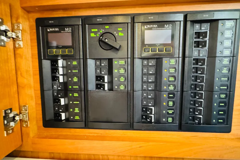 Slide: The Image of Electrical control panel on 2025 Back Cove 34O boat, featuring multiple switches and displays. - 40