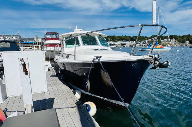 Slide: The Image of 2025 Back Cove 34O yacht docked at marina under clear blue sky. - 42