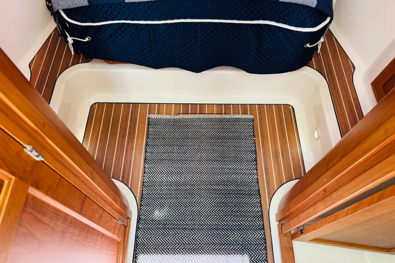 Slide: The Image of Interior of 2025 Back Cove 34O boat with wood flooring and patterned rug. - 8