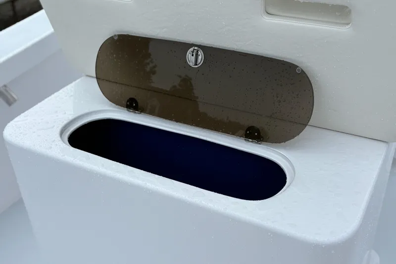 Slide: The Image of Boat storage compartment on Weaver 270, 2025 model, with wet surface and open lid. - 10