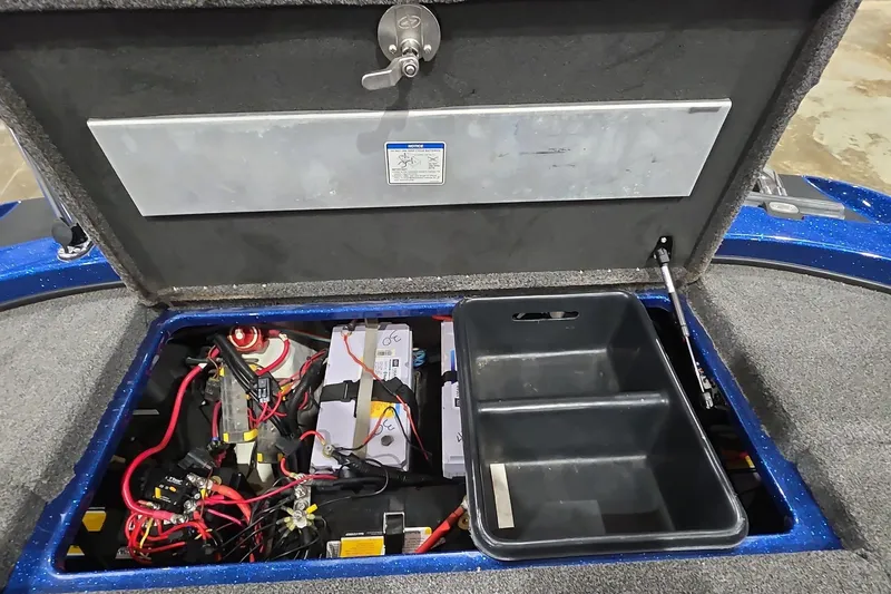 Slide: The Image of 2016 Nitro Z21 boat battery compartment with wiring and storage tray. - 14