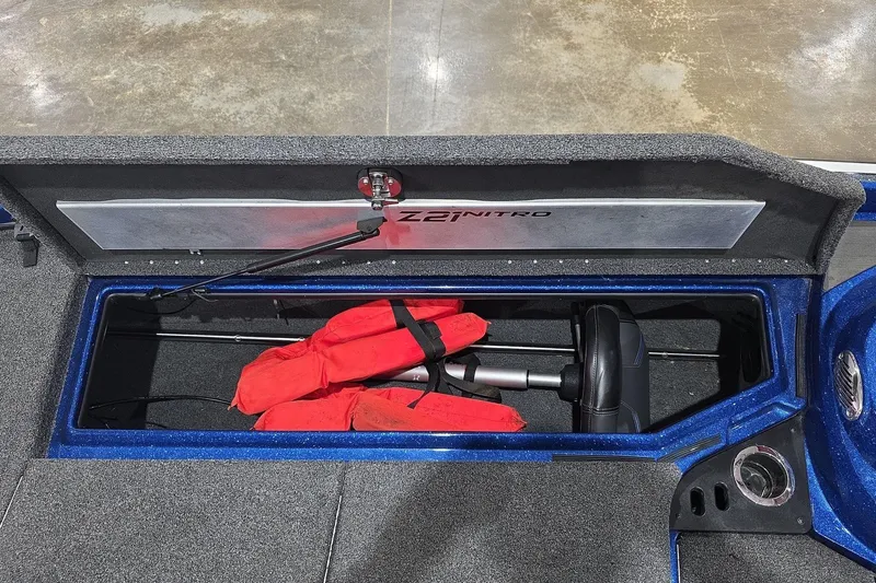 Slide: The Image of 2016 Nitro Z21 boat storage compartment with life jackets and equipment. - 31