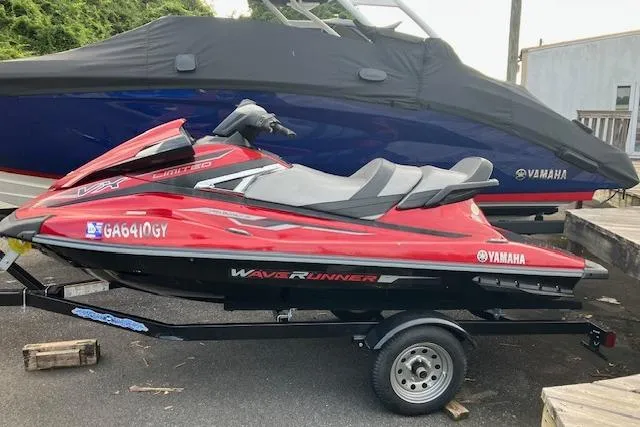 The Image of 2019 Yamaha WaveRunner VX Limited in red on a trailer, parked outdoors. - 0