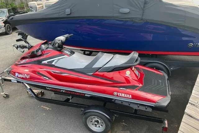 Slide: The Image of 2019 Yamaha WaveRunner VX Limited in red on a trailer, parked outdoors. - 7