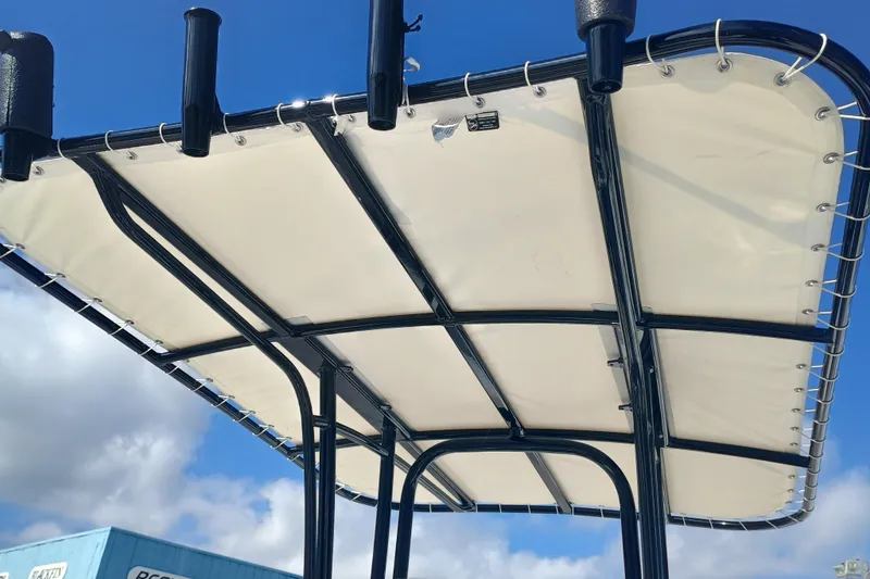 Slide: The Image of 2026 Robalo R200 Center Console T-top against blue sky. - 11