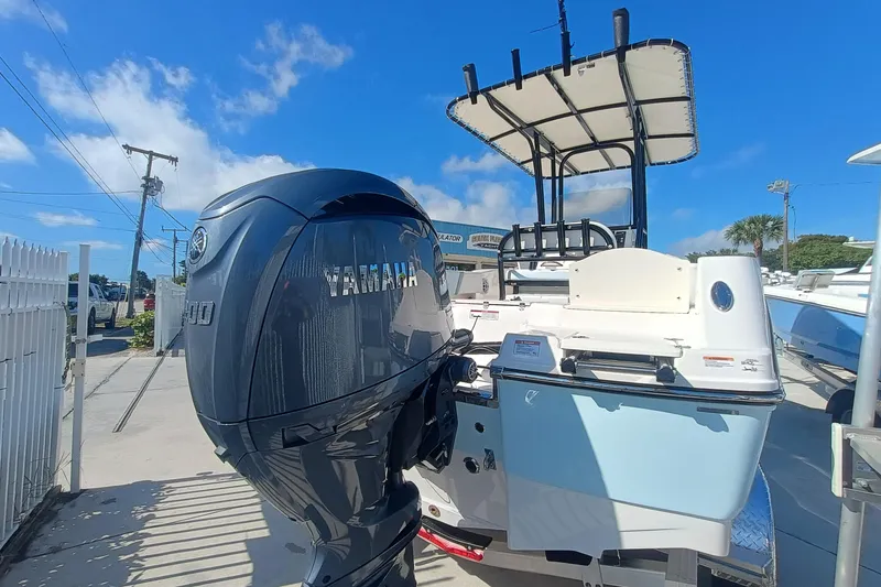Slide: The Image of 2026 Robalo R200 Center Console boat with Yamaha outboard motor, docked under clear blue sky. - 19