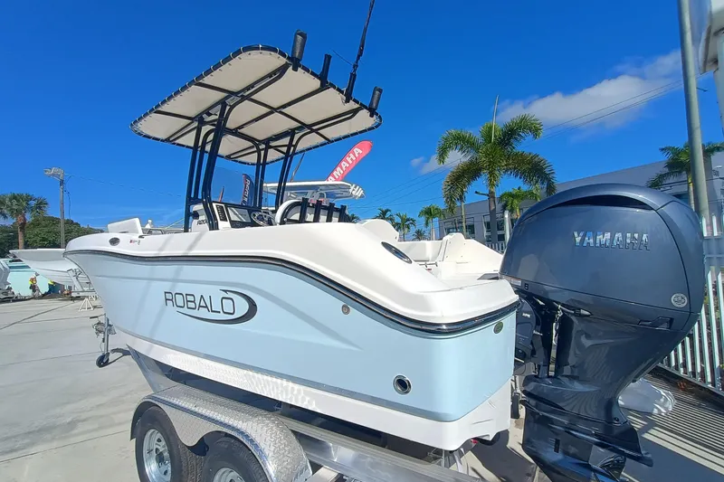 Slide: The Image of 2026 Robalo R200 Center Console boat with Yamaha engine, parked outdoors. - 21