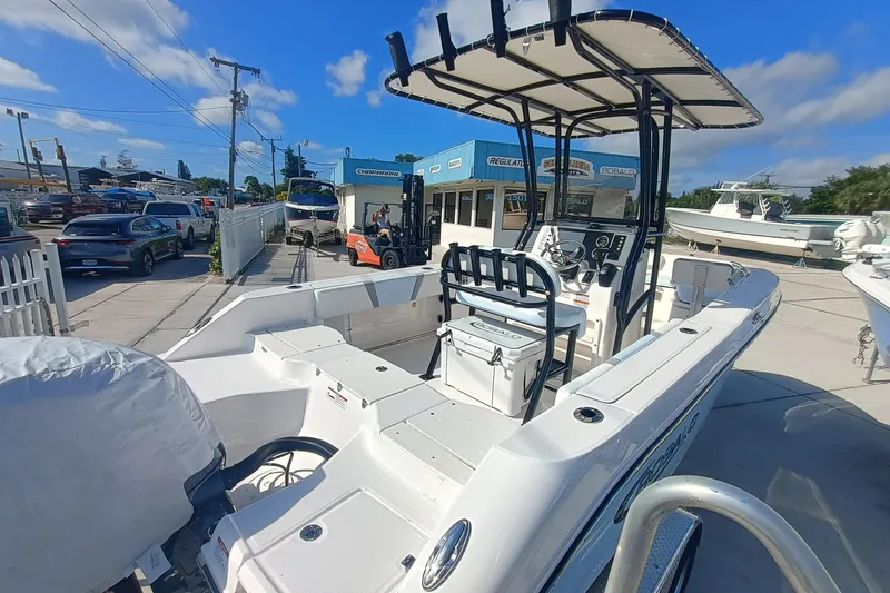 Slide: The Image of 2026 Robalo R200 Center Console boat at a dealership under clear blue skies. - 22