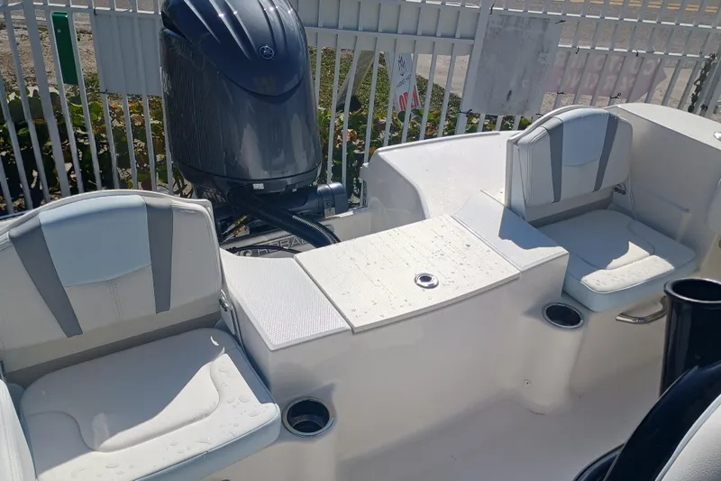 Slide: The Image of 2026 Robalo R200 Center Console boat interior with seating and engine view. - 24