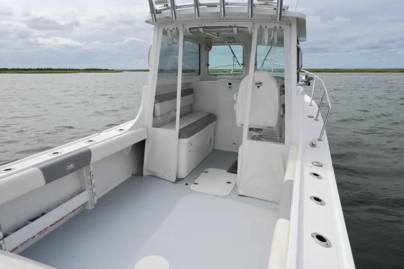 Slide: The Image of 2022 Steiger Craft 255DV Miami boat on water, showcasing spacious deck and cabin. - 12