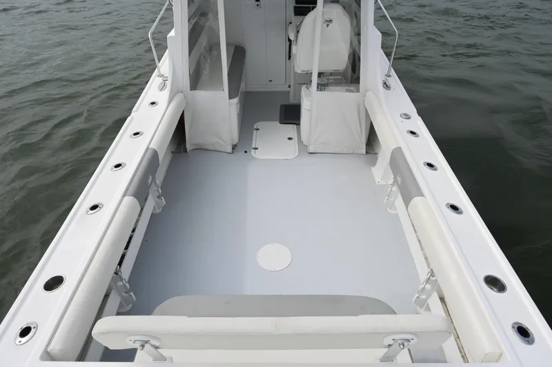 Slide: The Image of 2022 Steiger Craft 255DV Miami boat deck with seating, on calm water. - 13