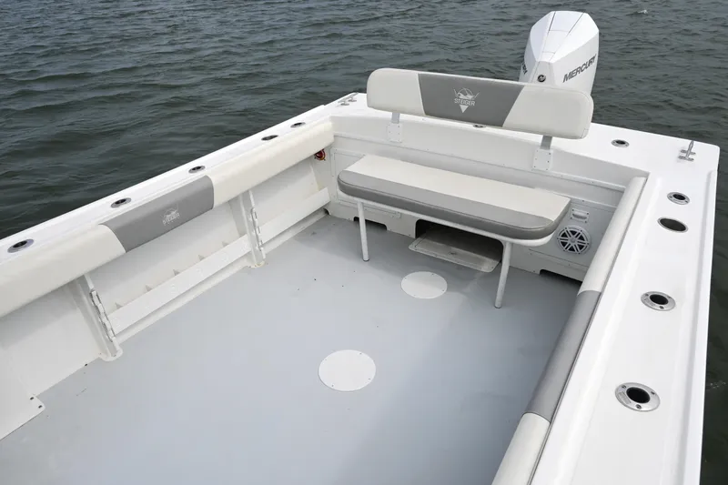 Slide: The Image of 2022 Steiger Craft 255DV Miami boat deck with seating, on calm water. - 15