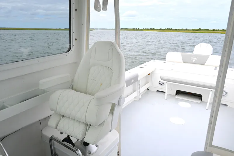 Slide: The Image of 2022 Steiger Craft 255DV Miami boat interior with white seating and ocean view. - 25