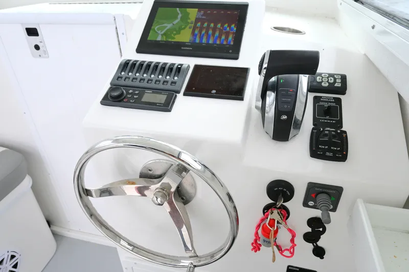 Slide: The Image of Helm of 2022 Steiger Craft 255DV Miami with steering wheel and navigation controls. - 29